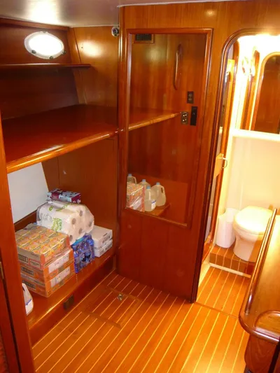 Vitamin Sea Yacht Photos Pics 1990 Viking Cockpit Motor Yacht interior with wooden cabinetry and stocked supplies.