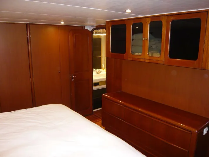 Vitamin Sea Yacht Photos Pics Interior of 1990 Viking Cockpit Motor Yacht with wooden cabinetry and cozy bedroom.