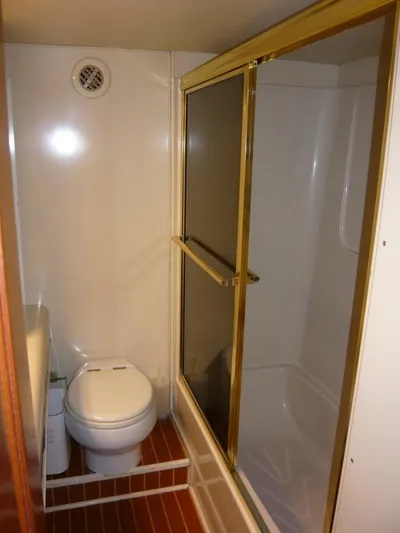 Vitamin Sea Yacht Photos Pics Bathroom interior of 1990 Viking Cockpit Motor Yacht with shower and toilet.