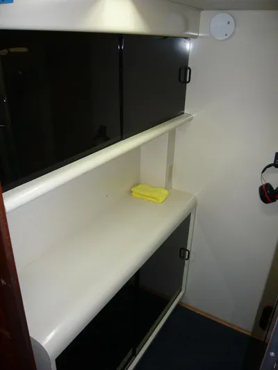 Vitamin Sea Yacht Photos Pics Interior of 1990 Viking Cockpit Motor Yacht with storage shelves and a yellow cloth.