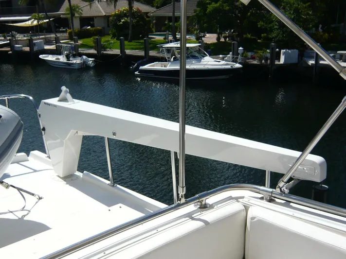 Vitamin Sea Yacht Photos Pics 1990 Viking Cockpit Motor Yacht deck with davit, overlooking marina with boats.
