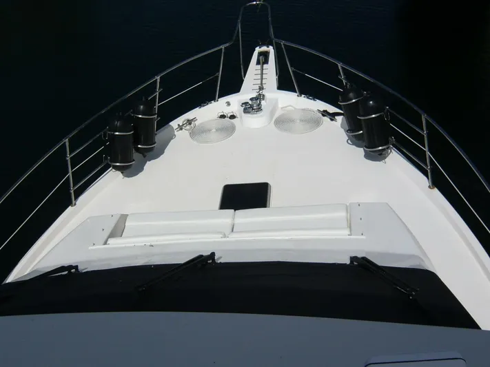 Vitamin Sea Yacht Photos Pics Bow view of 1990 Viking Cockpit Motor Yacht with railings and deck equipment.