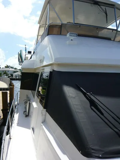 Vitamin Sea Yacht Photos Pics 1990 Viking Cockpit Motor Yacht docked, showcasing sleek design and spacious upper deck.