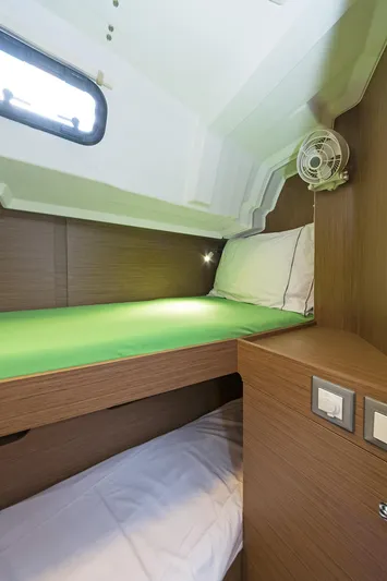  Yacht Photos Pics Cozy cabin interior of 2020 Beneteau Oceanis 46.1 yacht with bunk beds and wooden finish.