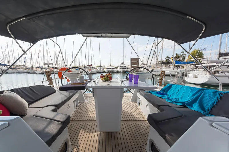  Yacht Photos Pics Luxurious 2020 Beneteau Oceanis 46.1 yacht interior with seating and table, docked at marina.