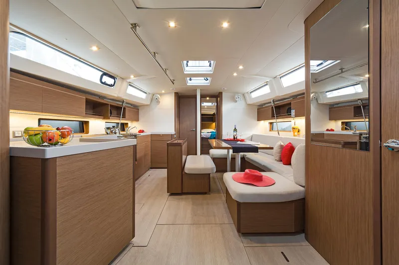  Yacht Photos Pics Luxurious interior of 2020 Beneteau Oceanis 46.1 yacht with modern wood finish and spacious seating.