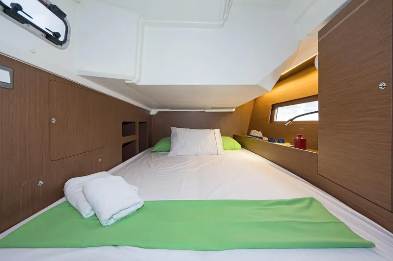  Yacht Photos Pics Cozy cabin interior of 2020 Beneteau Oceanis 46.1 yacht with neatly arranged bedding.
