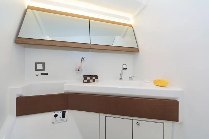  Yacht Photos Pics Modern bathroom in 2020 Beneteau Oceanis 46.1 yacht with sleek fixtures and storage.