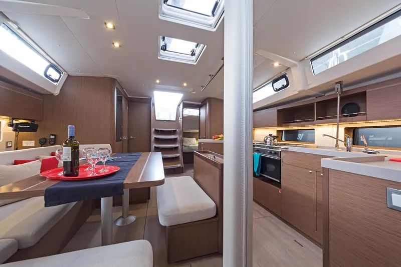  Yacht Photos Pics Luxurious interior of 2020 Beneteau Oceanis 46.1 yacht with modern kitchen and dining area.