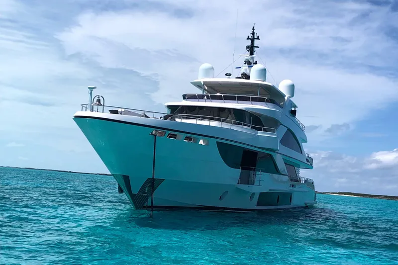  Yacht Photos Pics Luxurious 2026 Majesty 140 yacht on clear turquoise waters under a blue sky.