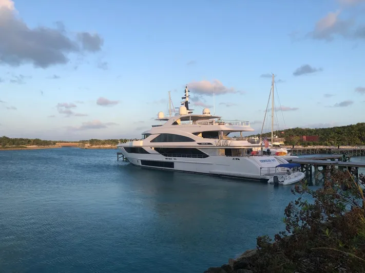  Yacht Photos Pics Luxury yacht Majesty 140, 2026 model, docked in serene waters at sunset.