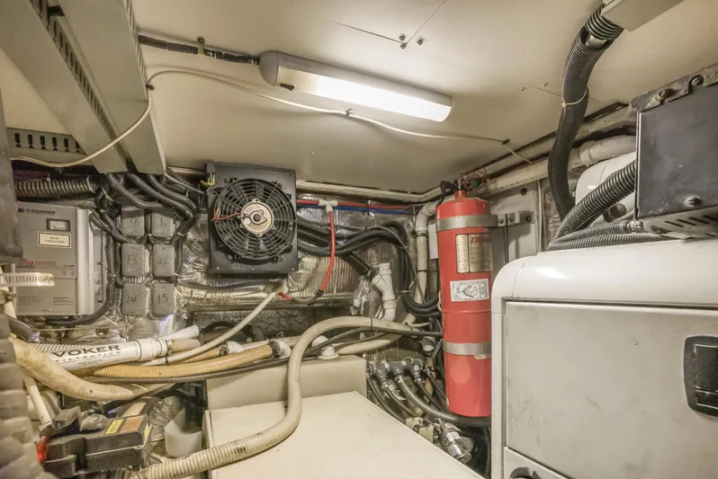 Lemonade Yacht Photos Pics Engine room of 2001 Carver 466 Motor Yacht with equipment and fire extinguisher.