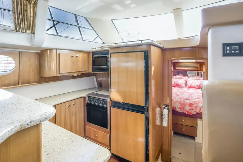 Lemonade Yacht Photos Pics Interior of 2001 Carver 466 Motor Yacht with kitchen and cozy bedroom.