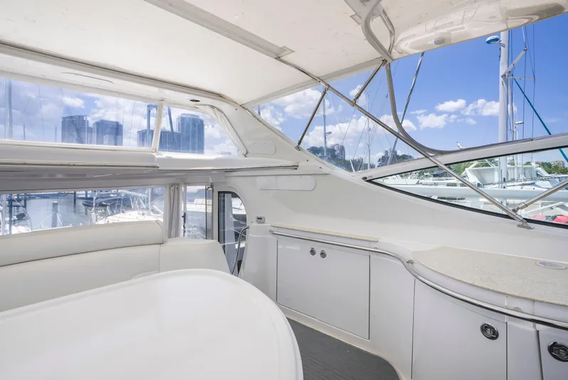 Lemonade Yacht Photos Pics 2001 Carver 466 Motor Yacht interior with white seating and cabinetry, marina view.