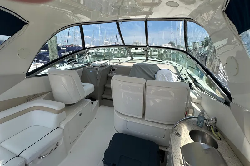  Yacht Photos Pics Interior of 2009 Sea Ray 350 Sundancer yacht with helm, seating, and kitchenette.