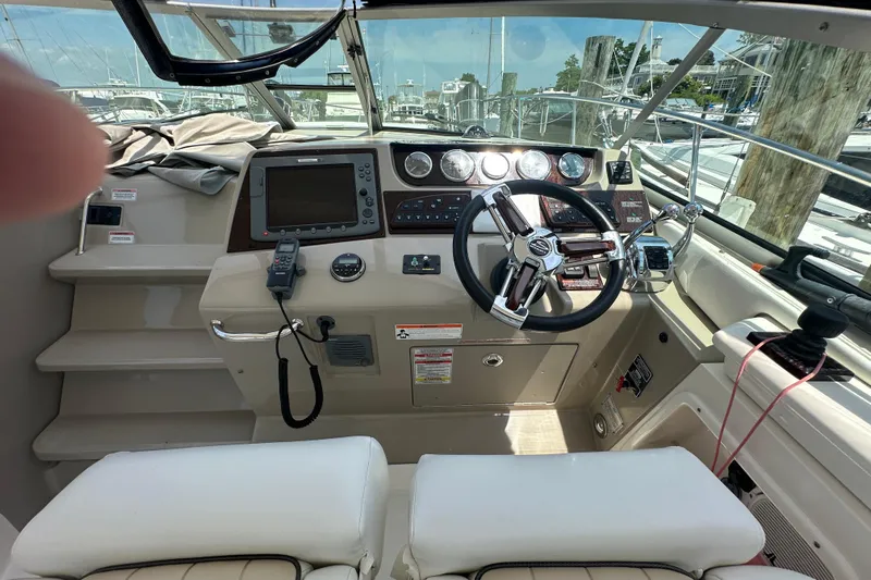  Yacht Photos Pics 2009 Sea Ray 350 Sundancer helm with steering wheel, navigation controls, and gauges.