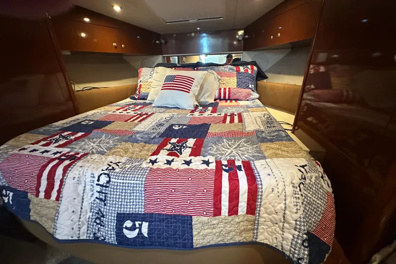  Yacht Photos Pics Cozy cabin interior of 2009 Sea Ray 350 Sundancer with patriotic quilted bedding.