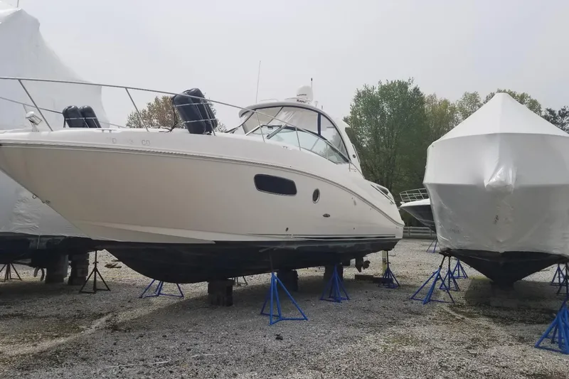  Yacht Photos Pics 2009 Sea Ray 350 Sundancer boat on stands, stored outdoors, with covered boats nearby.