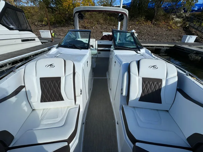 Amoore Yacht Photos Pics 2018 Monterey 328 Super Sport boat interior with luxurious seating at a dock.