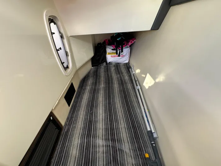 Amoore Yacht Photos Pics 2018 Monterey 328 Super Sport cabin interior with striped flooring and storage items.