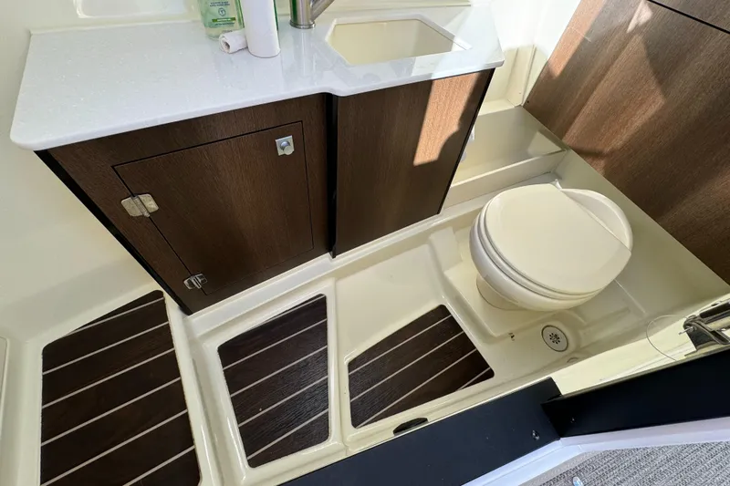 Amoore Yacht Photos Pics 2018 Monterey 328 Super Sport bathroom with modern fixtures and wood accents.