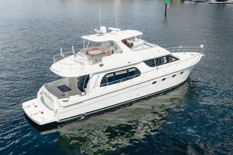 Sound Traveler Yacht Photos Pics 2005 Carver 56 Voyager yacht on calm water, showcasing sleek design and spacious deck.