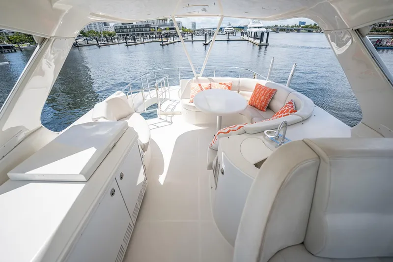 Sound Traveler Yacht Photos Pics Luxurious 2005 Carver 56 Voyager yacht deck with seating, table, and waterfront view.