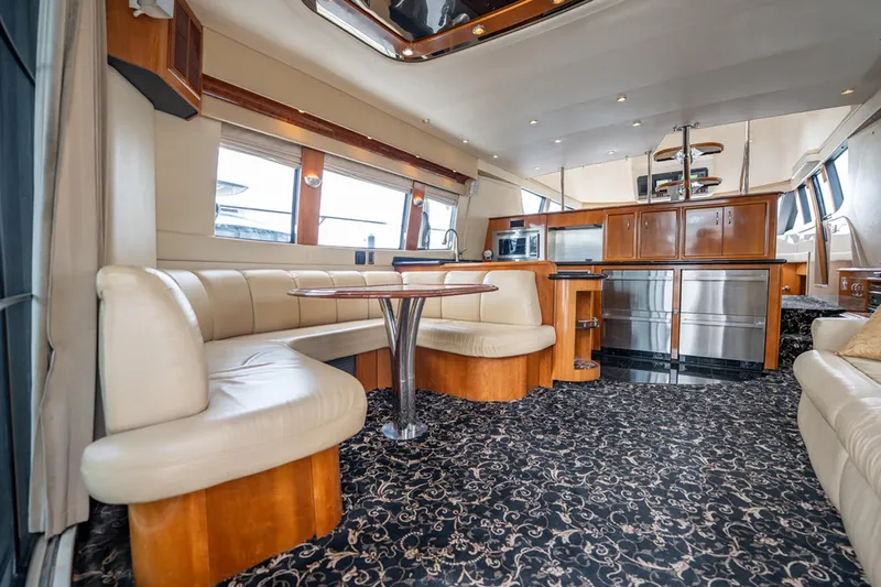 Sound Traveler Yacht Photos Pics Luxurious interior of 2005 Carver 56 Voyager yacht with elegant seating and modern kitchen amenities.