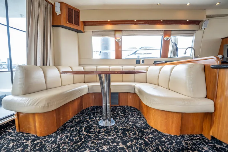 Sound Traveler Yacht Photos Pics Luxurious interior of 2005 Carver 56 Voyager yacht with elegant seating and table.