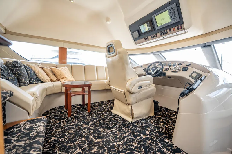 Sound Traveler Yacht Photos Pics Luxurious interior of 2005 Carver 56 Voyager yacht with plush seating and modern helm.