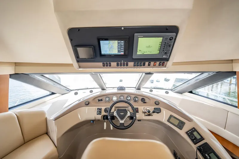 Sound Traveler Yacht Photos Pics 2005 Carver 56 Voyager yacht helm with navigation screens and steering wheel.