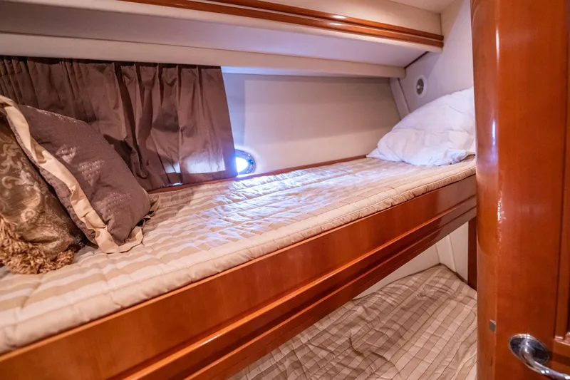 Sound Traveler Yacht Photos Pics Cozy bunk beds in 2005 Carver 56 Voyager yacht cabin with elegant wood finish.