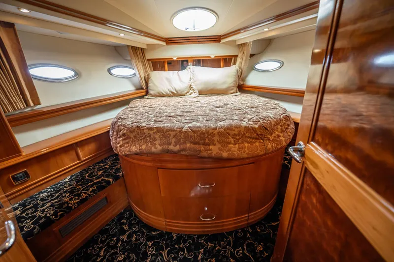 Sound Traveler Yacht Photos Pics Luxurious bedroom interior of 2005 Carver 56 Voyager yacht with elegant wood finish.