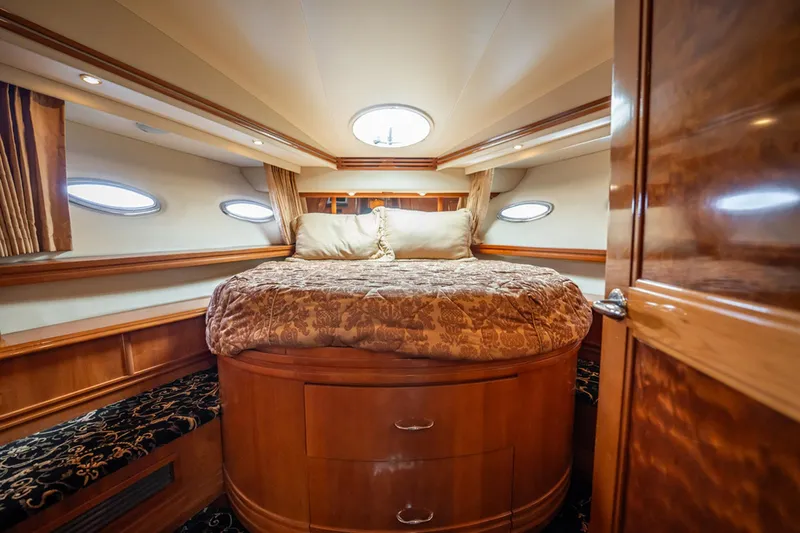Sound Traveler Yacht Photos Pics Luxurious bedroom interior of 2005 Carver 56 Voyager yacht with elegant wood finishes.