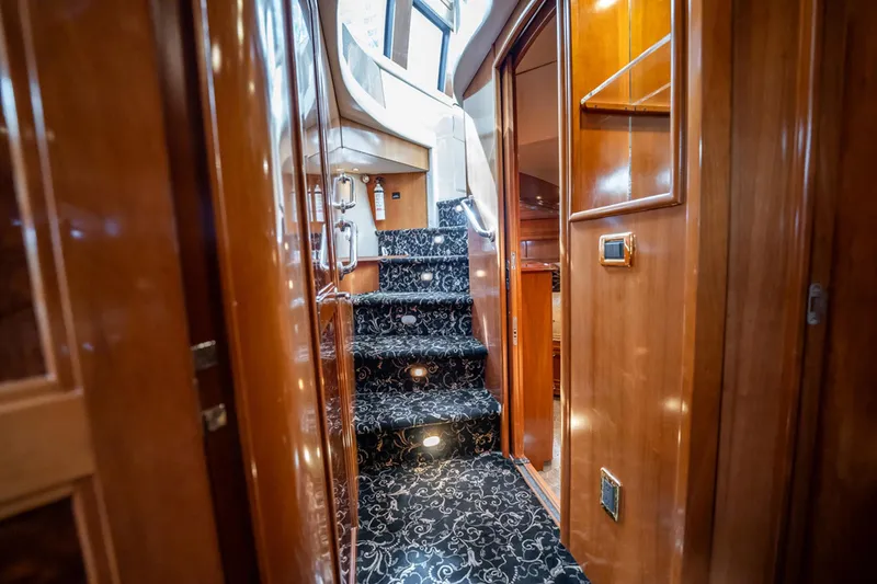 Sound Traveler Yacht Photos Pics Interior of 2005 Carver 56 Voyager yacht with elegant wooden finish and carpeted stairs.