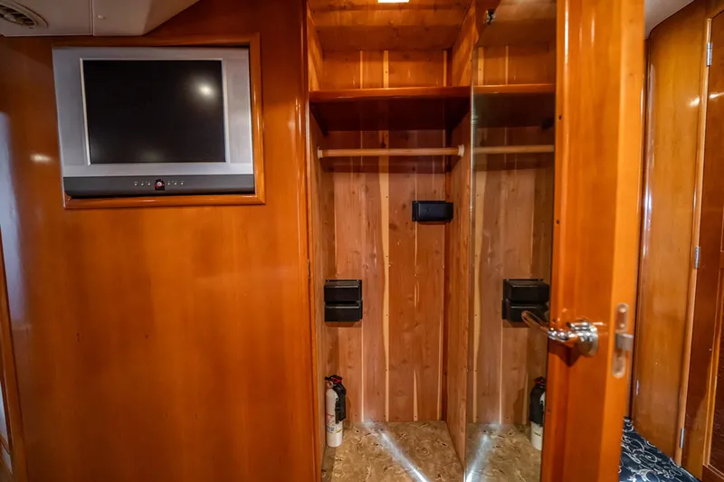 Sound Traveler Yacht Photos Pics 2005 Carver 56 Voyager interior with wooden closet and wall-mounted TV.