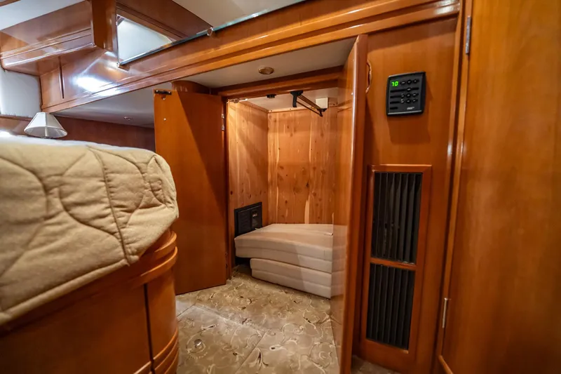 Sound Traveler Yacht Photos Pics Luxurious interior of 2005 Carver 56 Voyager yacht with wood paneling and plush bedding.