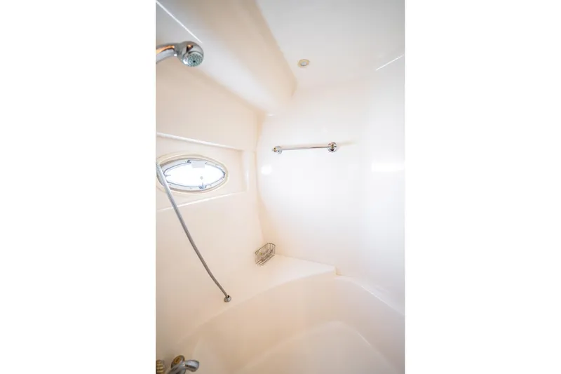 Sound Traveler Yacht Photos Pics Shower area in 2005 Carver 56 Voyager yacht with porthole and handheld showerhead.