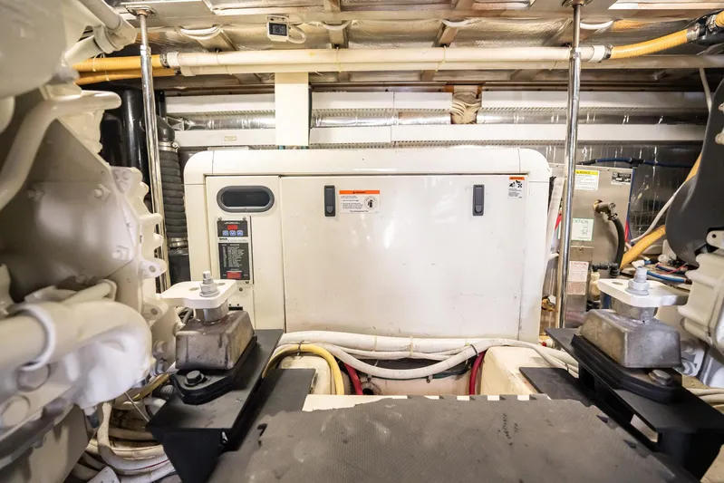 Sound Traveler Yacht Photos Pics Engine room of a 2005 Carver 56 Voyager yacht, featuring machinery and piping.