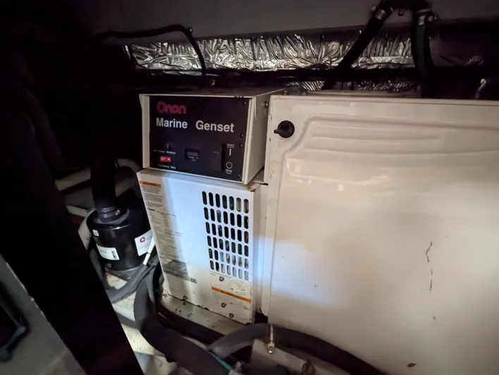 Dakota Silver Yacht Photos Pics Onan Marine Genset in 2006 Meridian 368 engine room, showing generator and surrounding components.