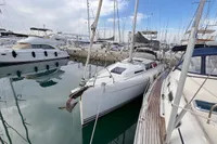 2014 Hanse 345 sailboat docked in a marina, surrounded by other boats.