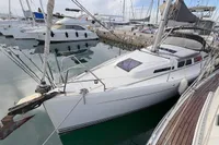 2014 Hanse 345 sailboat docked in a marina, surrounded by other boats.