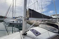 Sailboat Hanse 345, 2014 model, docked in marina with other yachts under cloudy sky.