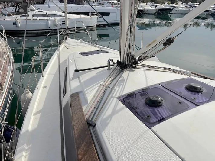 Sunshine Yacht Photos Pics Sailboat deck view of 2014 Hanse 345 in marina, surrounded by other boats.