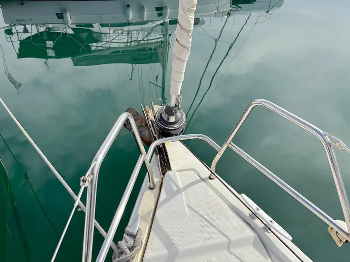 Sunshine Yacht Photos Pics Bow of 2014 Hanse 345 sailboat with calm water reflection.