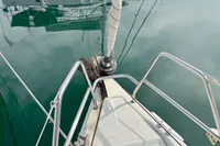 Bow of 2014 Hanse 345 sailboat with calm water reflection.