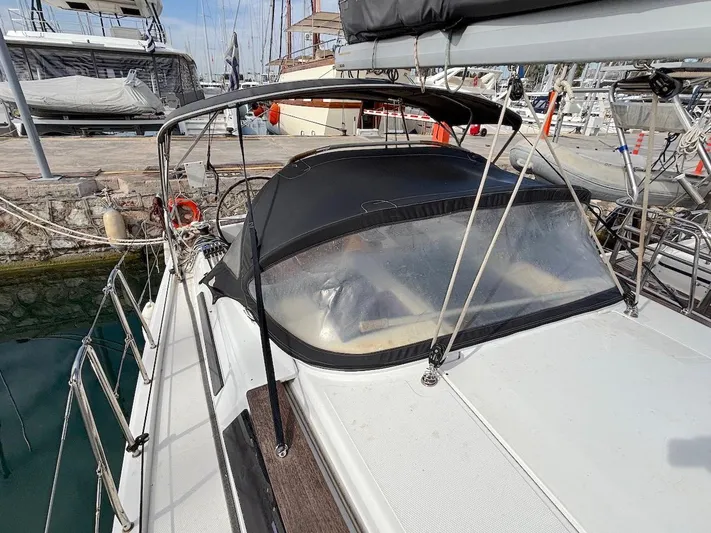 Sunshine Yacht Photos Pics Sailboat Hanse 345 (2014) docked, featuring a black canopy and clear windows.