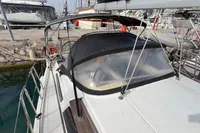 Sailboat Hanse 345 (2014) docked, featuring a black canopy and clear windows.