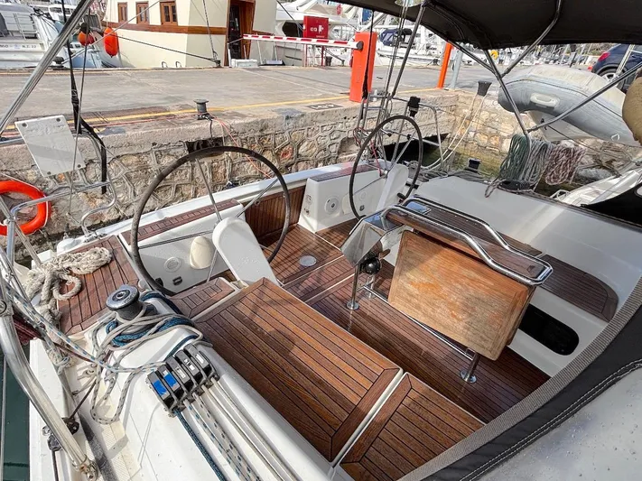 Sunshine Yacht Photos Pics Cockpit of 2014 Hanse 345 sailboat with dual steering wheels and wooden deck.