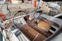 Cockpit of 2014 Hanse 345 sailboat with dual steering wheels and wooden deck.